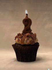 fully edible dark chocolate kosher vegan candles with a flammable edible roasted almond wick. eat the wick and candle.